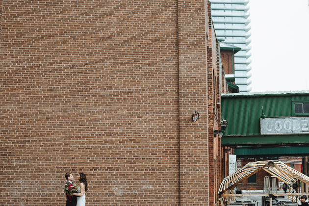 Fermenting Cellar Toronto WeddingFermenting Cellar Toronto Wedding. Outdoor creative portrait session with the bride and groom in the Distillery District against a brick wall backdrop.