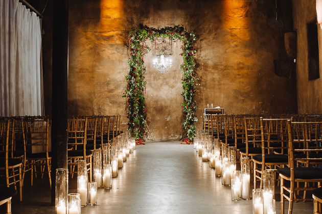 Fermenting Cellar Toronto Wedding Photographer. Candlelit lined pathway to a floral framed altar.