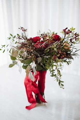 Fermenting Cellar Toronto Wedding Photography. Wild, romantic boquet with red roses and red ribbon.