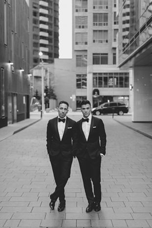 Grooms posing for formal portraits in front of the Four Seasons Hotel 