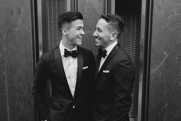 A candid moment between the grooms at their Four Seasons Hotel Wedding